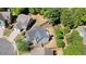 An aerial view displays the home, its backyard, and landscaping within the surrounding neighborhood at 2525 Ashton Dr, Roswell, GA 30076