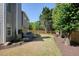 Landscaped backyard with mature trees, a wooden fence, and a patio at 2525 Ashton Dr, Roswell, GA 30076