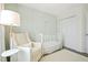 Bright Bedroom with a white crib, neutral walls, a comfortable chair, and closet at 2525 Ashton Dr, Roswell, GA 30076