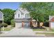 Charming two-story home with a two-car garage and well-manicured lawn and mature landscaping at 2525 Ashton Dr, Roswell, GA 30076