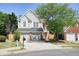 Charming two-story home with a two-car garage and well-manicured lawn and mature landscaping at 2525 Ashton Dr, Roswell, GA 30076