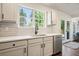 This kitchen features new stainless appliances, and solid countertops with a large sink and view to the patio at 2525 Ashton Dr, Roswell, GA 30076