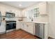 Well-lit kitchen featuring stainless steel appliances, stylish hardware, and wood flooring at 2525 Ashton Dr, Roswell, GA 30076