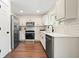 This cozy kitchen boasts stainless steel appliances, white cabinetry and modern hardware at 2525 Ashton Dr, Roswell, GA 30076