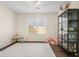 Bright living room with white walls, dark floors, white rug, and a black shelving unit at 2525 Ashton Dr, Roswell, GA 30076