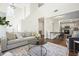 Bright and airy living room features high ceilings and an open floor plan with a view to the kitchen and dining area at 2525 Ashton Dr, Roswell, GA 30076