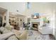 Open-concept living area with a fireplace, hardwood floors, and seamless flow to the kitchen and dining space at 2525 Ashton Dr, Roswell, GA 30076