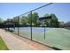 Well-maintained tennis court with a high fence, providing a dedicated space for sports and recreation at 2525 Ashton Dr, Roswell, GA 30076
