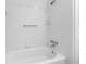 All-white bathroom features a tub, shower, and chrome fixtures at 446 Harold Ne Ave, Atlanta, GA 30307