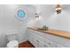Bathroom features a unique window, decorative sconces, and an earth tone vanity at 446 Harold Ne Ave, Atlanta, GA 30307