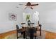 A stylish dining area features a glass table, decorative rug, black chairs, and ample natural light at 446 Harold Ne Ave, Atlanta, GA 30307