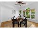 A stylish dining area features a glass table, decorative rug, black chairs, and ample natural light at 446 Harold Ne Ave, Atlanta, GA 30307