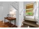 Inviting entryway with hardwood floors, staircase, stylish decor, and bright window at 446 Harold Ne Ave, Atlanta, GA 30307