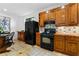 Warm kitchen featuring wooden cabinets, black appliances, and a breakfast nook at 446 Harold Ne Ave, Atlanta, GA 30307