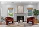 Elegant living room with fireplace, comfortable seating, and natural light from two windows at 446 Harold Ne Ave, Atlanta, GA 30307