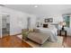 Bright main bedroom featuring hardwood floors, a chaise lounge, and a walk-in closet at 446 Harold Ne Ave, Atlanta, GA 30307