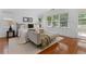 A bright main bedroom features windows, hardwood floors, a comfortable bed, and stylish decor at 446 Harold Ne Ave, Atlanta, GA 30307