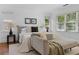 Bright main bedroom featuring hardwood floors, a chaise lounge, and natural light at 446 Harold Ne Ave, Atlanta, GA 30307
