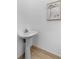 Powder room features a white pedestal sink, wood-look tile and decorative print at 446 Harold Ne Ave, Atlanta, GA 30307