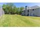 Spacious backyard with a lush green lawn, trees and privacy fence at 100 Wyngate Chase, Stockbridge, GA 30281