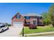 Charming two-story brick home with a well-manicured lawn and a two-car garage at 100 Wyngate Chase, Stockbridge, GA 30281