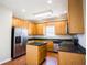 Kitchen featuring wood cabinets, granite counters, stainless appliances and wood floors at 100 Wyngate Chase, Stockbridge, GA 30281