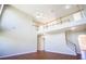 View of the living room with a soaring ceiling, upper level overlook and staircase at 100 Wyngate Chase, Stockbridge, GA 30281