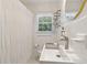 Contemporary bathroom with a unique sink, stylish fixtures, and tiled walls, naturally lit by a window at 1301 Amanda Cir, Decatur, GA 30033