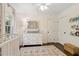 Comfortable Bedroom with a changing table, decorative mirror, and colorful books on display at 1301 Amanda Cir, Decatur, GA 30033