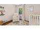 Bright Bedroom featuring a white rocking chair, patterned rug, and a view of the outdoors at 1301 Amanda Cir, Decatur, GA 30033