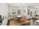 Bright dining room with hardwood floors, a beaded chandelier, and a view of lush greenery outside at 1301 Amanda Cir, Decatur, GA 30033
