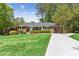 Inviting brick home boasts a well-maintained lawn and manicured landscaping leading to a private driveway at 1301 Amanda Cir, Decatur, GA 30033