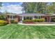 Charming brick home features a lush green lawn and colorful landscaping, enhancing its curb appeal at 1301 Amanda Cir, Decatur, GA 30033