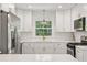 Modern kitchen boasts white cabinetry, stainless steel appliances, and quartz countertops at 1301 Amanda Cir, Decatur, GA 30033