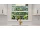 Close-up showcases a kitchen sink with a gold faucet and a view of lush greenery from the window at 1301 Amanda Cir, Decatur, GA 30033
