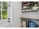Organized laundry area featuring built-in shelving, storage space, and access to the outdoors at 1301 Amanda Cir, Decatur, GA 30033