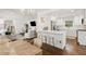 Open-concept living room features a bright, modern kitchen, breakfast bar, and hardwood floors at 1301 Amanda Cir, Decatur, GA 30033