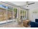 Sunroom with sliding glass doors leading to private patio, seating, and privacy fence at 1301 Amanda Cir, Decatur, GA 30033