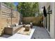 Outdoor patio featuring a modern sectional, string lights, and a privacy fence for cozy entertaining at 1301 Amanda Cir, Decatur, GA 30033