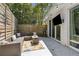 Outdoor patio with a comfortable seating area, string lights, and a view of the lush backyard at 1301 Amanda Cir, Decatur, GA 30033