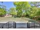Lush backyard with plenty of green space, framed by mature trees and view of house at 1851 Mount Vernon Rd, Dunwoody, GA 30338