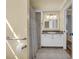 Bathroom with vanity and shower featuring granite countertops, white cabinets, and modern fixtures at 1851 Mount Vernon Rd, Dunwoody, GA 30338