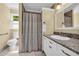 Well-lit bathroom featuring a shower, toilet, and vanity with granite countertops and modern fixtures at 1851 Mount Vernon Rd, Dunwoody, GA 30338