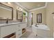 This bathroom features double vanity sinks, soaking tub and neutral wall coloring at 1851 Mount Vernon Rd, Dunwoody, GA 30338