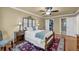 This stylish bedroom includes a ceiling fan, hardwood floors, closet, and an ensuite bathroom at 1851 Mount Vernon Rd, Dunwoody, GA 30338