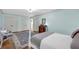 Serene bedroom with light blue walls, hardwood floors, and a view into the ensuite bathroom at 1851 Mount Vernon Rd, Dunwoody, GA 30338