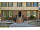 Elegant home entrance with brick steps and iron railings, framed by mature landscaping at 1851 Mount Vernon Rd, Dunwoody, GA 30338