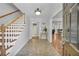 Welcoming foyer with hardwood floors, staircase, and view into other rooms of the house at 1851 Mount Vernon Rd, Dunwoody, GA 30338