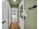 Hallway with hardwood floors, a decorative key hanger, and access to laundry and outdoor spaces at 1851 Mount Vernon Rd, Dunwoody, GA 30338