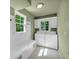 Functional laundry room with a built-in bench, overhead cabinets, and a window to let in natural light at 1851 Mount Vernon Rd, Dunwoody, GA 30338